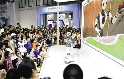 观众在参观展出的智能机器人进行舞蹈表演.jpeg